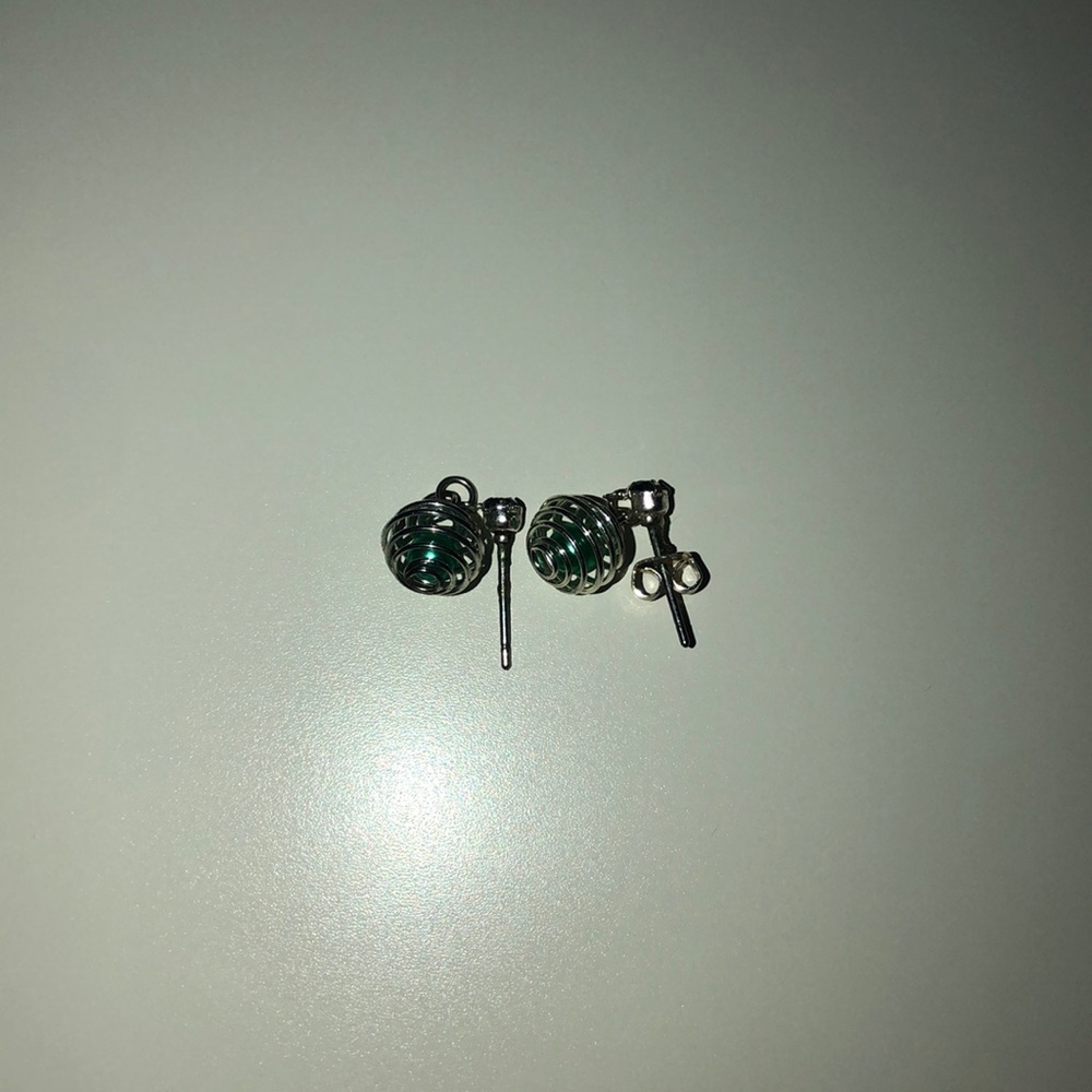 Claires dark green ball inside of silver earring